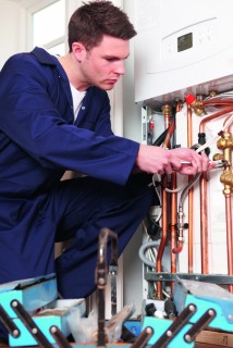 Engineer Servicing Central Heating Boiler